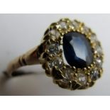 A diamond and blue stone cluster ring, centre stone approx 7 x 9 mm, size O,