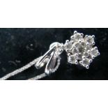 A 9ct white gold snowflake pendant and chain,