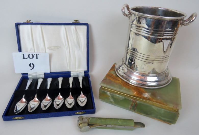 A silver plated wine cooler, an onyx cigar box with hinged lid, an onyx handled cigar cutter,