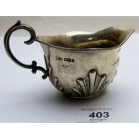 A silver cream jug with embossed fluting and double scroll handle, Sheffield 1905, approx 3.