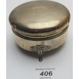 A silver circular trinket box,