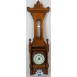 A Victorian 'Aesthetic Period' light oak wall aneroid barometer,