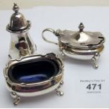 A silver three piece condiment set comprising of salt, pepper and mustard, blue liners,
