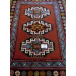 A 20th century Persian wool rug with three central medallions (153 cm x 210 cm approx) est: