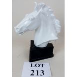 A Meissen white horse's head mounted on wooden plinth signed by Erich Oehme, dated 1949,