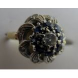 An 18ct gold sapphire and diamond cluster ring, centre diamond approx 15pts,