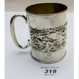 A silver embossed Christening mug decorated with hunting scene, Birmingham 1905,