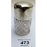 A cut glass scent bottle with silver top,