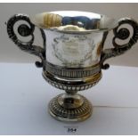 A heavy Georgian silver two handled trophy having elaborately decorated acanthus leaf handles,
