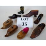 Two treen 'shoe' snuff boxes, four treen model shoes, a treen 'shoe' pin cushion,