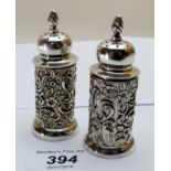 A pair of silver embossed peppers,