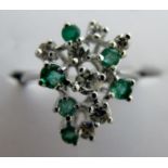 An 18ct white gold diamond and green stone ring, size M,