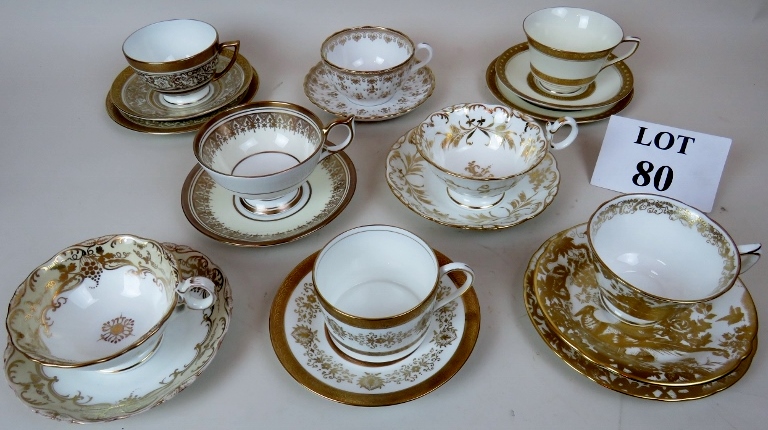 A pretty collection of eight 19th and 20th century gilt decorated porcelain cups & saucers and