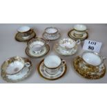 A pretty collection of eight 19th and 20th century gilt decorated porcelain cups & saucers and