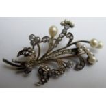 A diamond and pearl flower spray brooch, the four large diamonds measuring a total of 60pts,