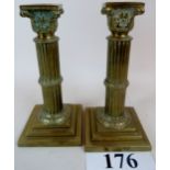 A pair of European brass candlesticks in the form of Corinthian columns,