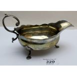 A Georgian silver sauce boat having acanthus leaf handle and pad feet, 1762,