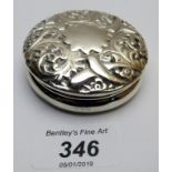 A silver embossed circular box,