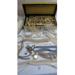 A large collection of simulated pearl necklaces, a 9ct gold signet ring,