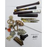 A 9ct gold rimmed amber cigarette holder, an enamelled amber cigarette holder, possibly French,