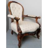 A Victorian carved mahogany framed gentleman's armchair upholstered in cream material est: