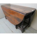 An 18th century oak gateleg dining table of good rich colour and patina,