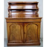 A Victorian mahogany chiffonier/side cabinet with two shelves over a long blind drawer and two