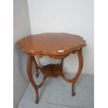 A 19th century carved mahogany occasional table, with a shaped top,