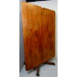 A 19th century mahogany rectangular tilt top breakfast table, terminating on a turned column,