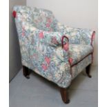 An Edwardian mahogany framed ladies armchair upholstered in floral material and in good condition