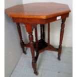 An octagonal mahogany occasional table, with decorative upright supports, c.