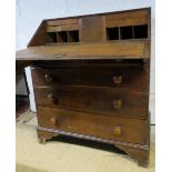 A Georgian oak bureau with a fall front flap, revealing a fitted interior,