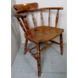 A carved oak captain's desk chair, with turned spindles,