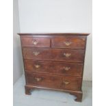 A Georgian country oak chest of two short over three long graduated drawers,