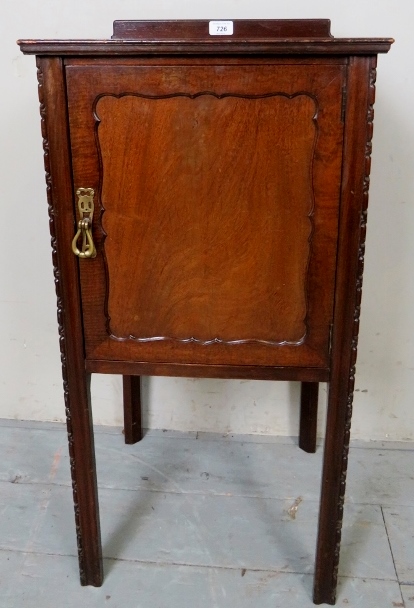 A 20th century mahogany bedside/pot cupboard, with a raised gallery rail to back,