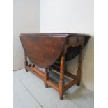 A 19th century oak gateleg dining table, with a single drawer to one end,