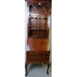 A 20th century slim bureau bookcase with a single glazed door, over a fall front flap,