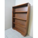 A 20th century mahogany slim line open bookcase, with three shelves,