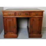 A small 19th century oak pedestal desk with a tooled green leather top over three drawers and with