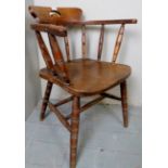 A carved oak captain's desk chair with turned spindle back, stretchers and legs, c.