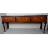 A Georgian oak sideboard with three deep drawers, each having brass handles and lock escutcheons,