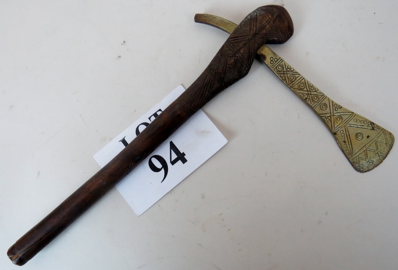 An old tribal brass axe with cut decorat