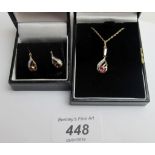 A 9ct gold ruby and diamond pendant on a