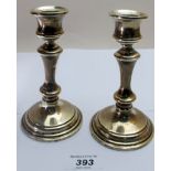 A pair of silver candlesticks, (one repa