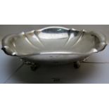 A large silver bowl on four scrolled fee