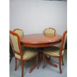 A 20th Century yew colour round dining t