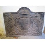 A cast iron fire back with a crest relie