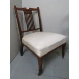 An Edwardian inlaid mahogany nursing cha