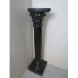A decorative carved and ebonised torcher