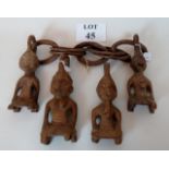 Tribal Art: A series of four carved wooden kneeling figures,